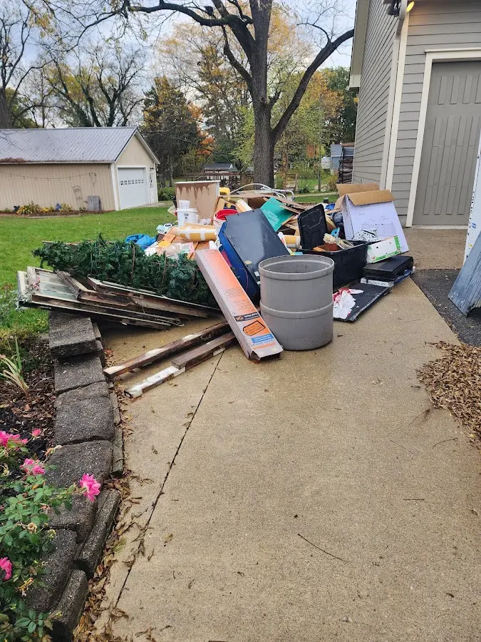 Dumpster being loaded with debris for 12 Yard Dumpster Rental in Norcross